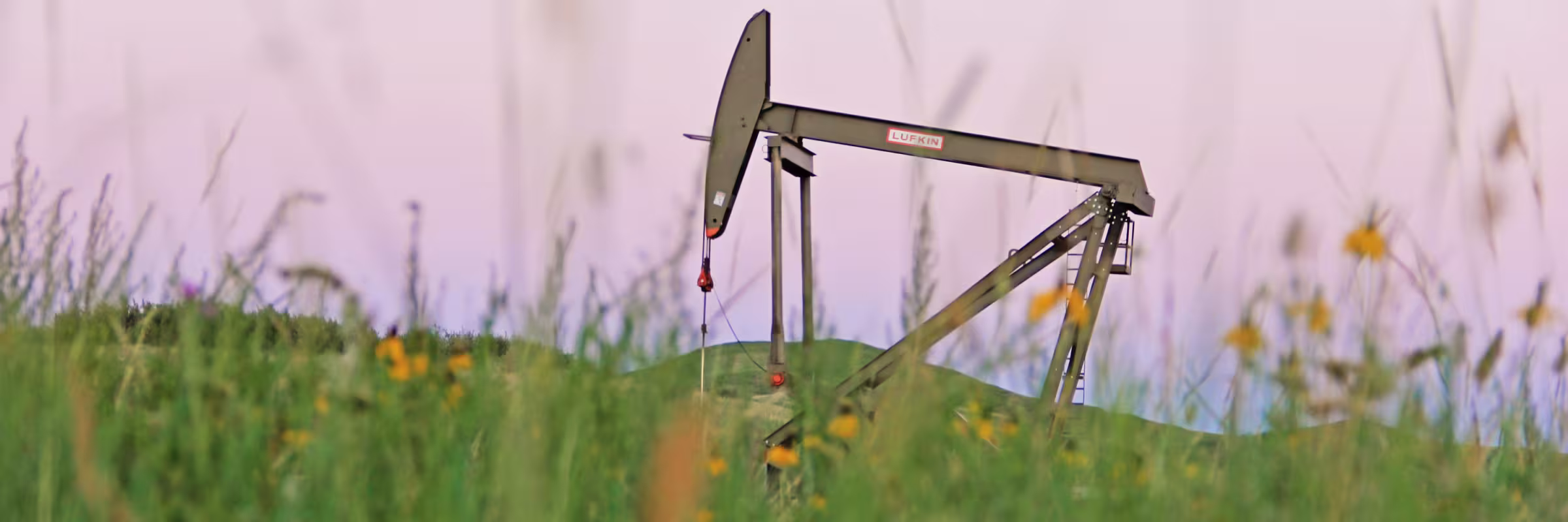 oil derrick in ND field at sunset